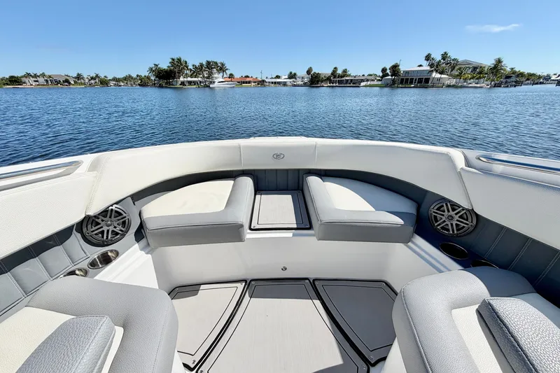 Slide: The Image of 2020 Cobalt 23SC boat interior with seating, on a sunny lake. - 25
