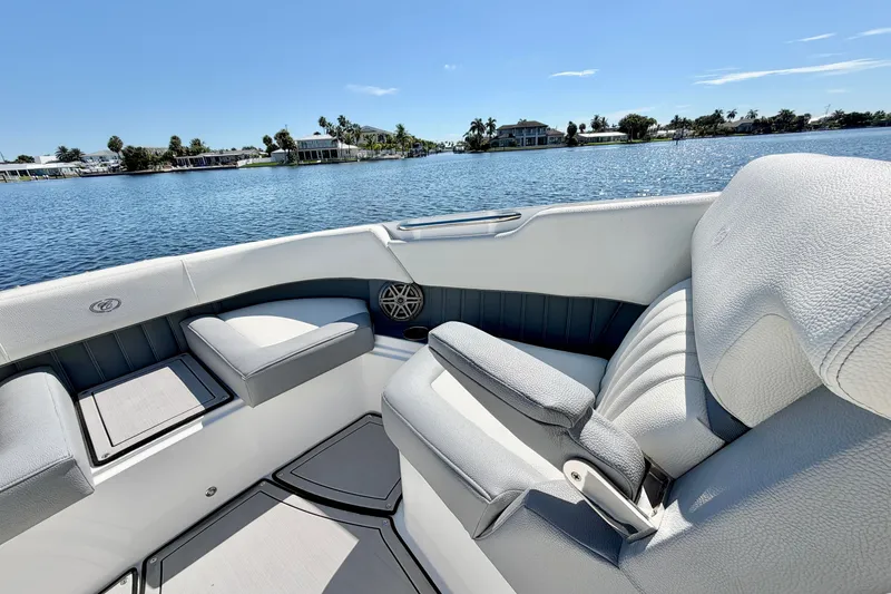 Slide: The Image of 2020 Cobalt 23SC boat interior with luxurious seating on a sunny lake. - 26