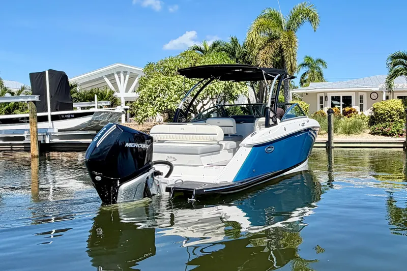 Slide: The Image of 2020 Cobalt 23SC boat docked in sunny waterfront setting with palm trees. - 3