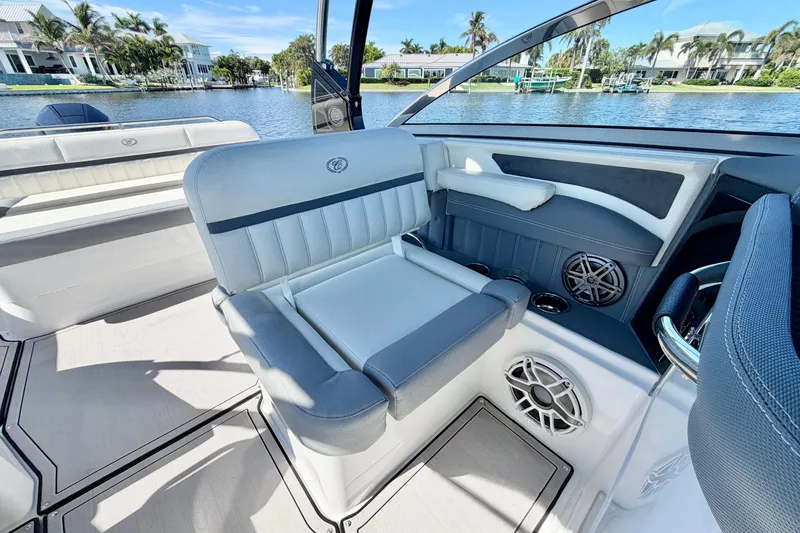 Slide: The Image of 2020 Cobalt 23SC boat interior with luxurious seating and modern design by the water. - 15