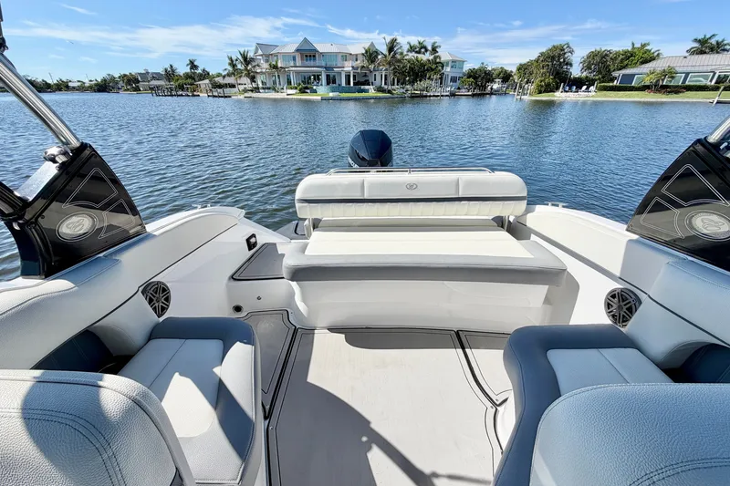 Slide: The Image of Cobalt 23SC 2020 boat interior with waterfront view and luxury homes. - 10