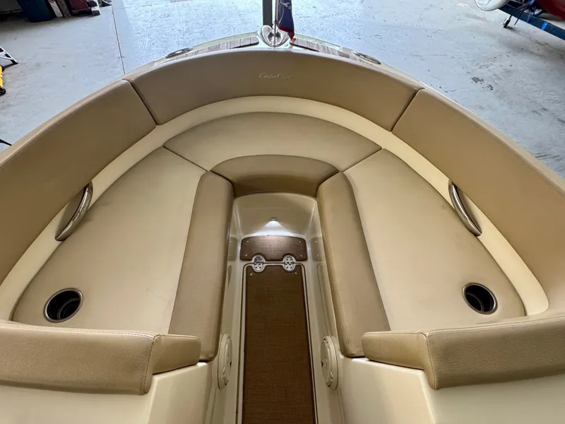 Slide: The Image of The image shows the bow area of a Chris-Craft Carina 21 boat with beige upholstery. - 30