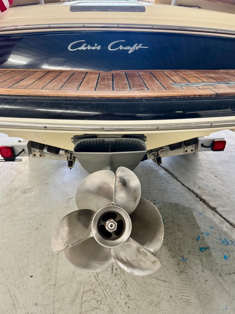 Slide: The Image of The image shows the stern of a Chris-Craft Carina 21 boat with a propeller. - 18