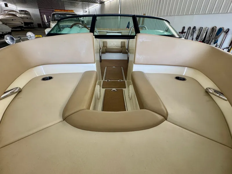Slide: The Image of The image shows the cockpit of a 2016 Chris-Craft Carina 21 with beige seating. - 31
