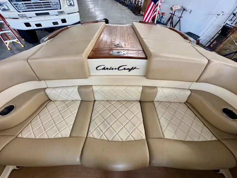 Slide: The Image of The image shows the beige and cream upholstery of a 2016 Chris-Craft Carina 21. - 21