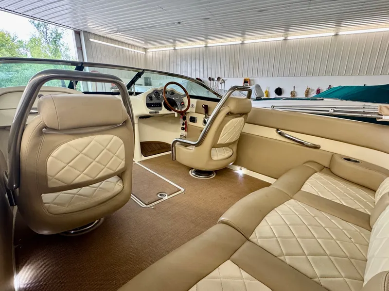 Slide: The Image of Interior of a 2016 Chris-Craft Carina 21 with beige leather seats and elegant detailing. - 24