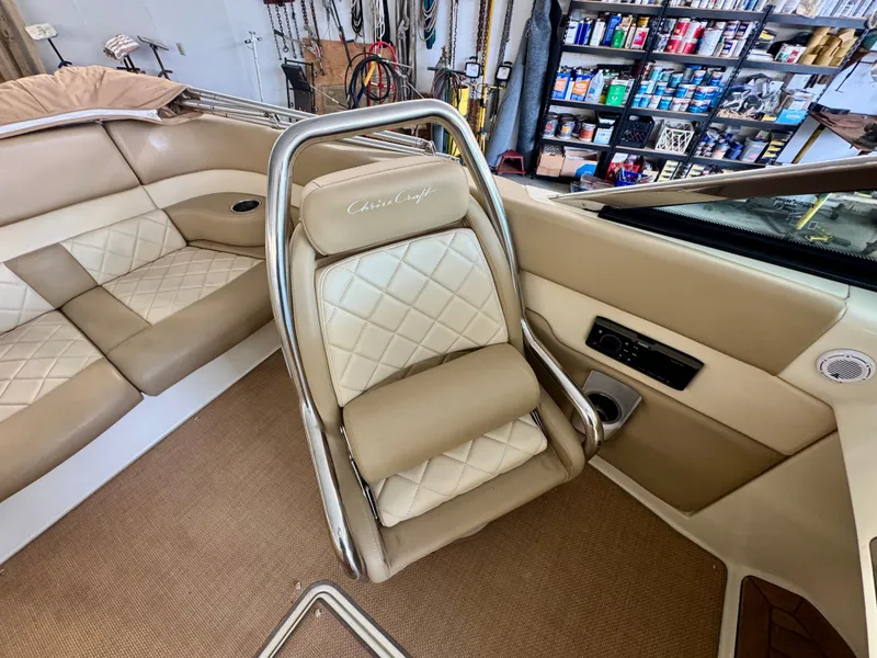 Slide: The Image of Interior of a 2016 Chris-Craft Carina 21 with beige leather seating and elegant details. - 28