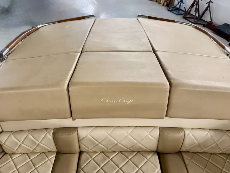 Slide: The Image of The image shows the beige upholstery of a 2016 Chris-Craft Carina 21. - 23