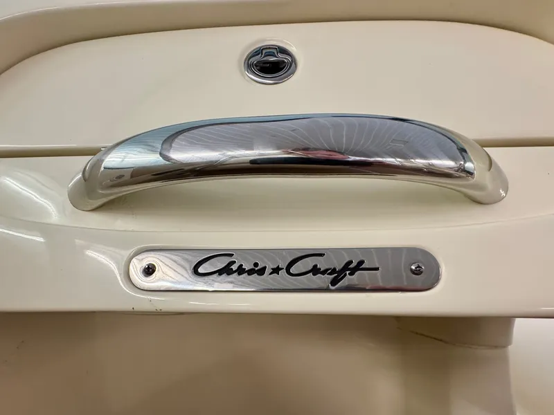 Slide: The Image of Close-up of a Chris-Craft Carina 21 boat with a shiny handle and logo. - 29