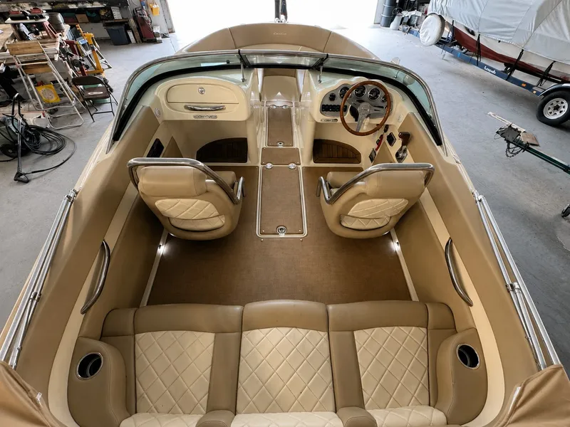 Slide: The Image of Interior view of a 2016 Chris-Craft Carina 21 boat with elegant leather seating. - 20
