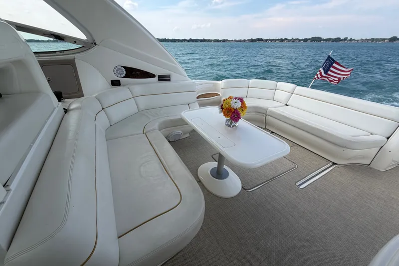 Slide: The Image of Luxurious 1998 Sea Ray Sundancer 540 yacht interior with white seating and table, American flag waving. - 28