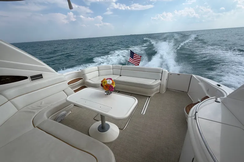 Slide: The Image of Luxurious 1998 Sea Ray Sundancer 540 yacht cruising with American flag and elegant seating area. - 26