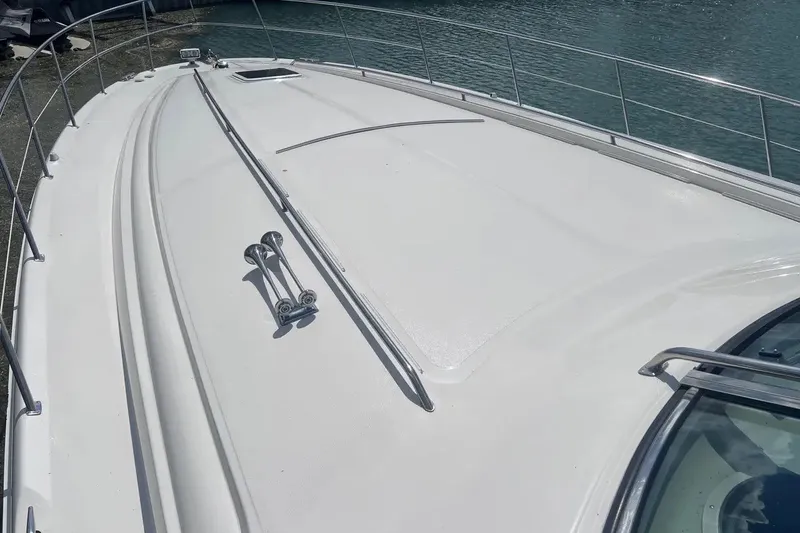 Slide: The Image of 1998 Sea Ray Sundancer 540 yacht deck with railing, docked by the water. - 38