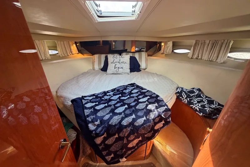 Slide: The Image of Cozy cabin interior of 1998 Sea Ray Sundancer 540 yacht with plush bedding. - 21