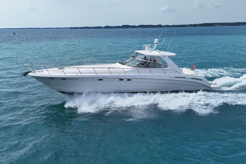 Slide: The Image of 1998 Sea Ray Sundancer 540 cruising on clear blue ocean waters. - 34