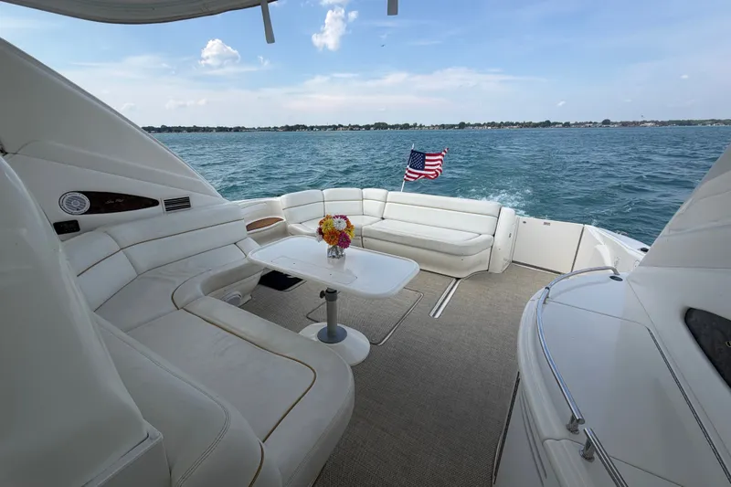 Slide: The Image of Luxurious 1998 Sea Ray Sundancer 540 yacht with spacious seating and American flag on open water. - 27