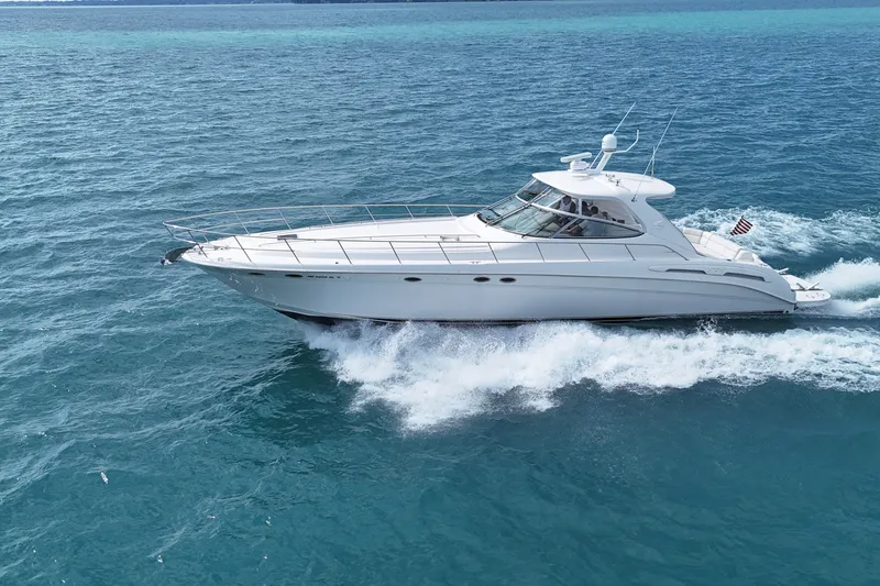 Slide: The Image of 1998 Sea Ray Sundancer 540 cruising on clear blue ocean waters. - 32