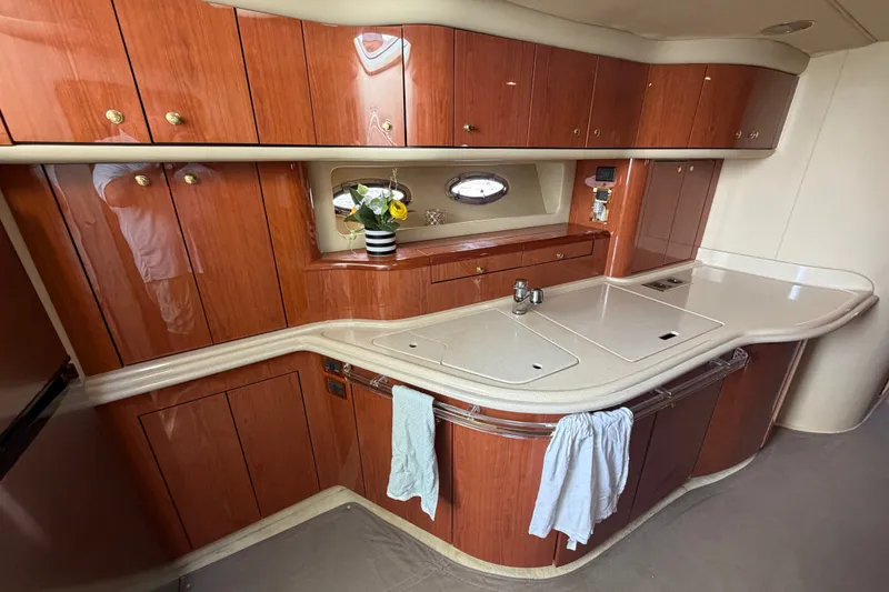 Slide: The Image of Luxurious 1998 Sea Ray Sundancer 540 yacht kitchen with elegant wood cabinetry and modern fixtures. - 14