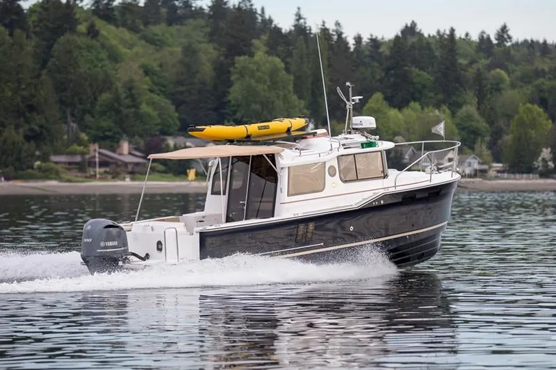 Slide: The Image of Manufacturer Provided Image: 2018 Ranger Tugs R-27 cruising on a lake with forested shoreline in the background. - 6