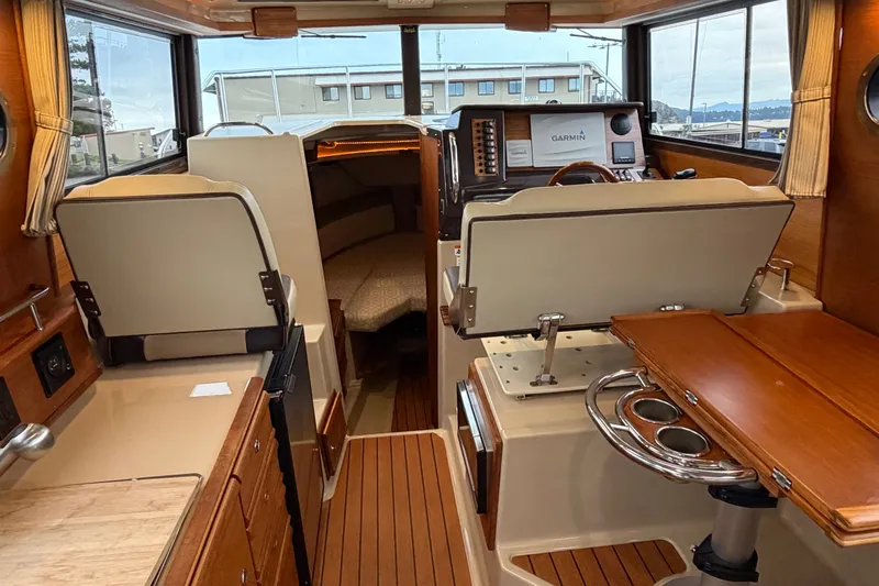 Slide: The Image of Interior of 2018 Ranger Tugs R-27 boat with helm, seating, and cabin area. - 1