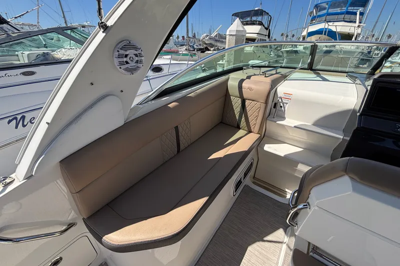 Slide: The Image of Interior of 2016 Sea Ray Sundancer 260 boat with beige seating and marina view. - 9