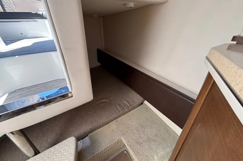 Slide: The Image of Interior cabin of 2016 Sea Ray Sundancer 260, featuring cozy sleeping area. - 20