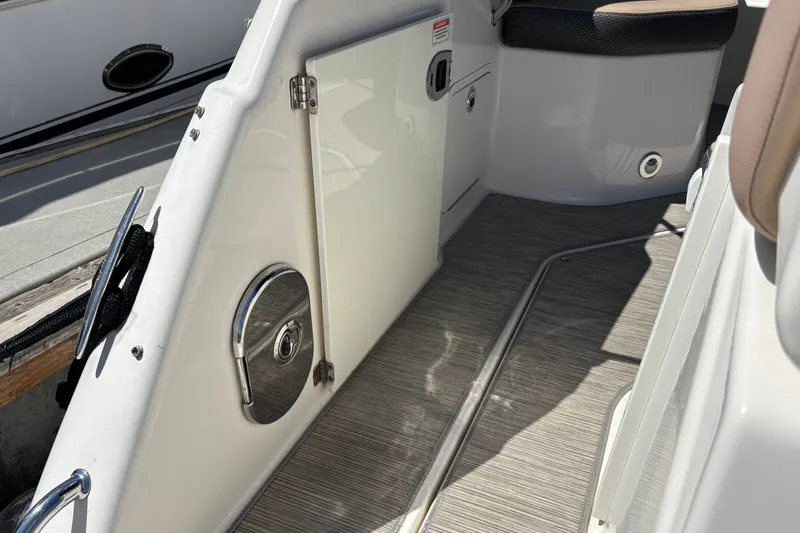 Slide: The Image of Interior view of a 2016 Sea Ray Sundancer 260 boat, showcasing sleek design and flooring. - 6