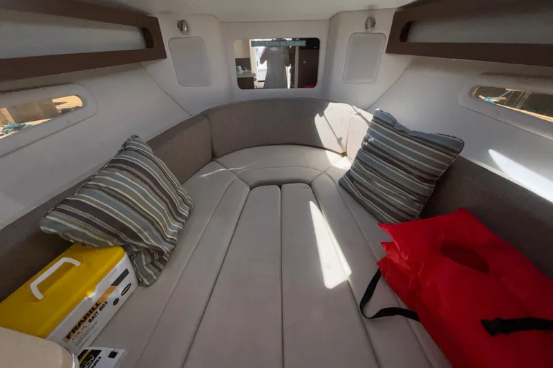 Slide: The Image of Interior cabin of 2016 Sea Ray Sundancer 260 with striped pillows and seating. - 18