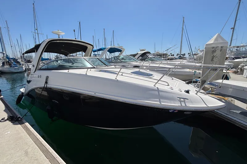 Slide: The Image of 2016 Sea Ray Sundancer 260 docked at marina, sleek design, sunny day. - 2