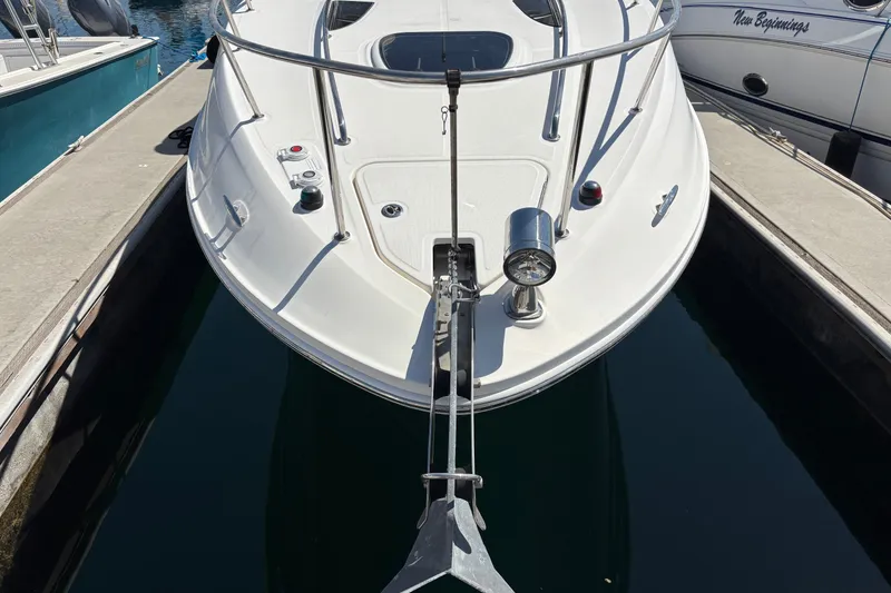 Slide: The Image of 2016 Sea Ray Sundancer 260 docked, showcasing sleek bow design and anchor. - 3