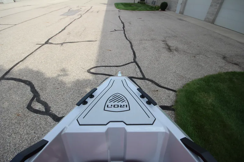 Slide: The Image of Bow view of 2027 IRON BOATS 707 T-top on pavement, showcasing sleek design. - 31