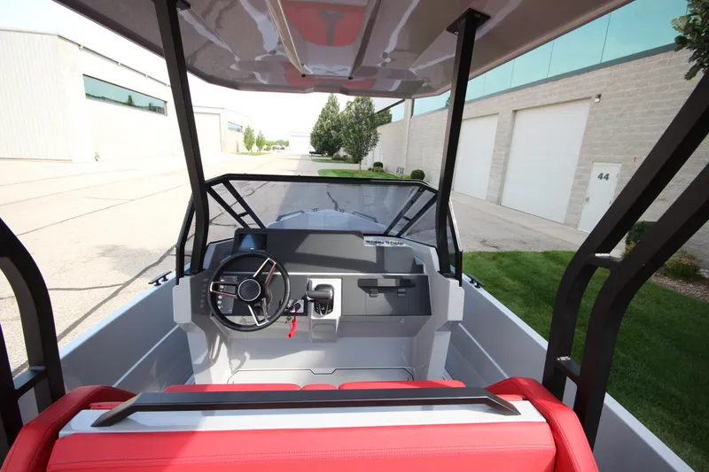 Slide: The Image of Interior view of 2027 IRON BOATS 707 T-top with red seating and modern controls. - 19