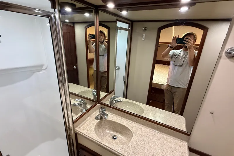 Slide: The Image of Interior of 2012 American Tug 365 bathroom with mirrored cabinets and sink. - 134