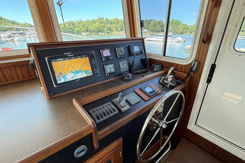 Slide: The Image of American Tug 365 helm with navigation equipment, 2012 model, overlooking marina. - 85