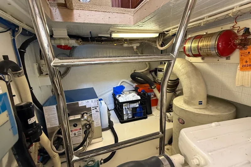 Slide: The Image of Engine room of a 2012 American Tug 365 with equipment and storage. - 25