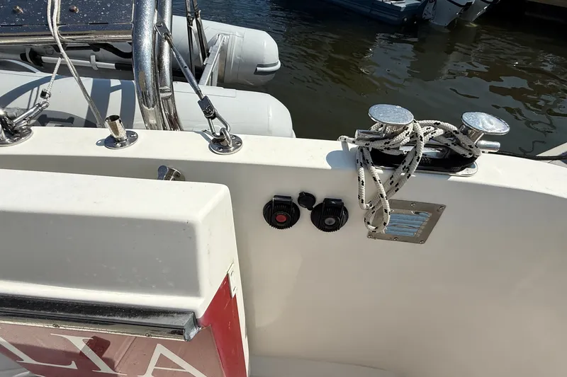 Slide: The Image of 2012 American Tug 365 boat deck with cleats and ropes by the water. - 39