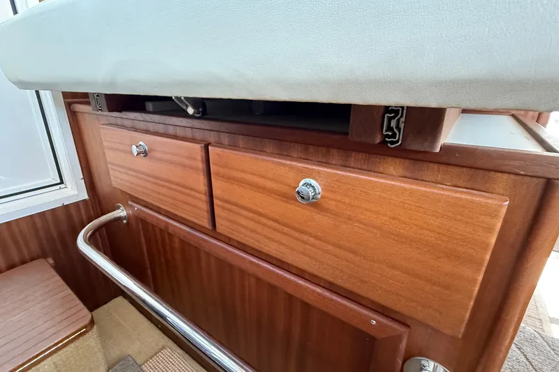 Slide: The Image of Wooden cabinetry with drawers in a 2012 American Tug 365 boat interior. - 97