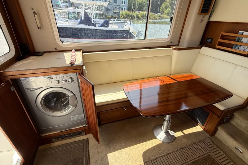 Slide: The Image of Interior of 2012 American Tug 365 with dining area and built-in washer. - 59