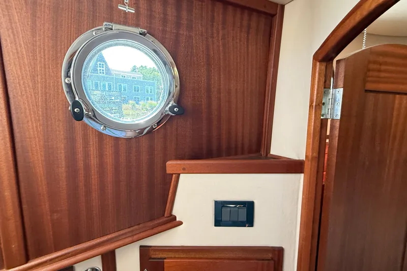 Slide: The Image of Interior of 2012 American Tug 365 with porthole and wooden finish. - 112