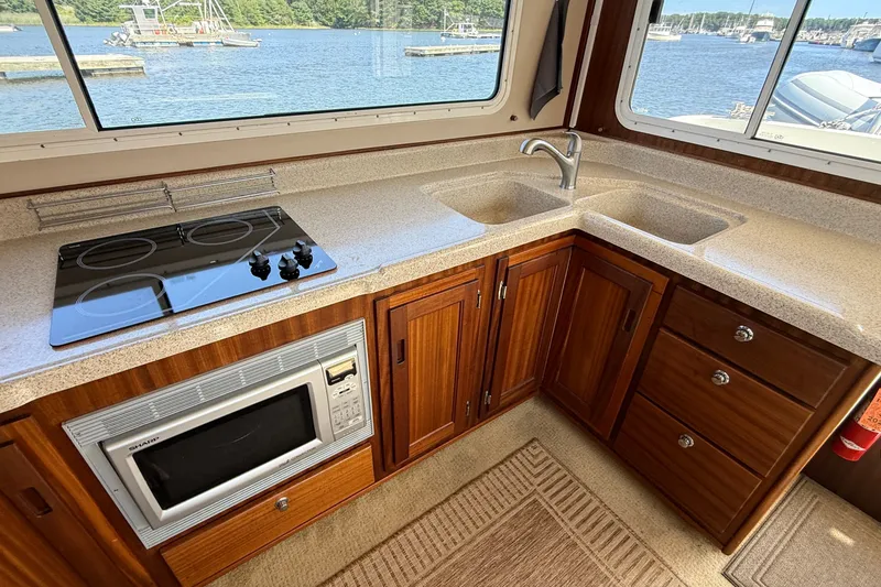 Slide: The Image of Modern kitchen in 2012 American Tug 365 boat with stove, microwave, and dual sink. - 52