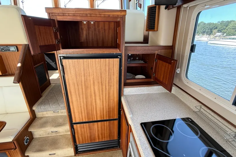 Slide: The Image of Interior of 2012 American Tug 365 with wooden cabinetry and modern kitchen appliances. - 50