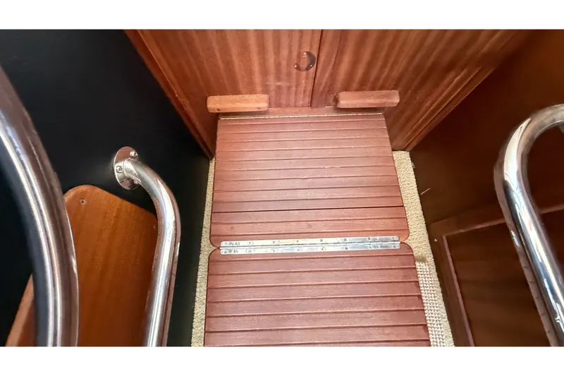 Slide: The Image of Interior view of 2012 American Tug 365 with wooden flooring and metal railings. - 95