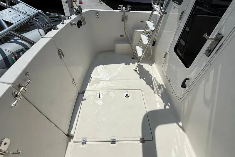 Slide: The Image of Spacious deck of 2012 American Tug 365 with ladder and storage hatches. - 40
