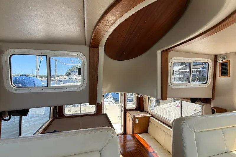 Slide: The Image of Interior of 2012 American Tug 365, featuring windows and seating area. - 91