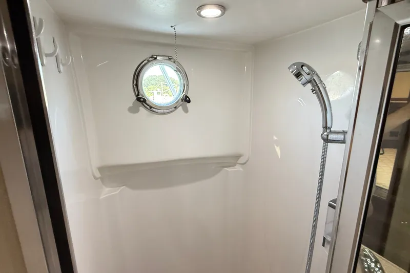 Slide: The Image of Shower area in 2012 American Tug 365 boat with porthole and handheld showerhead. - 130