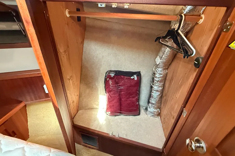 Slide: The Image of Interior closet of 2012 American Tug 365 with hangers and storage space. - 114