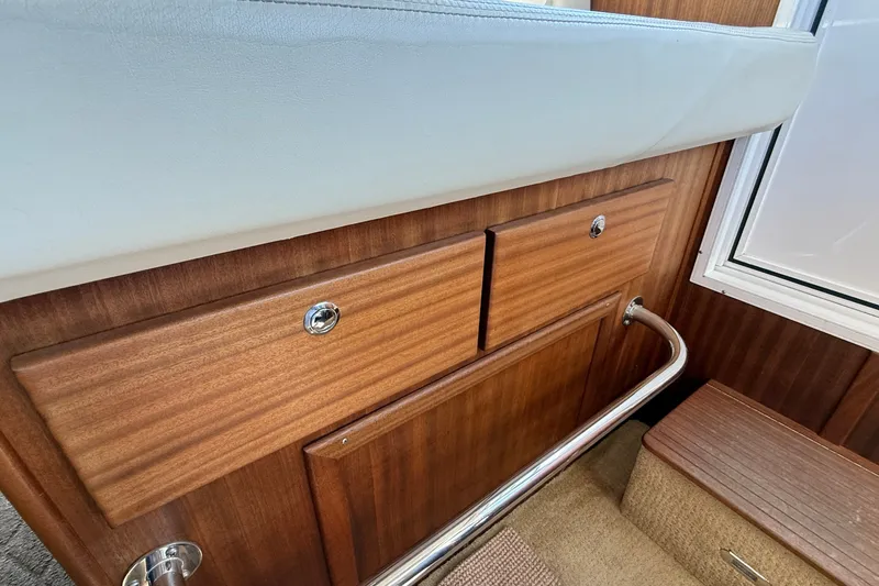 Slide: The Image of Interior of 2012 American Tug 365 with wooden cabinetry and metal railing. - 103