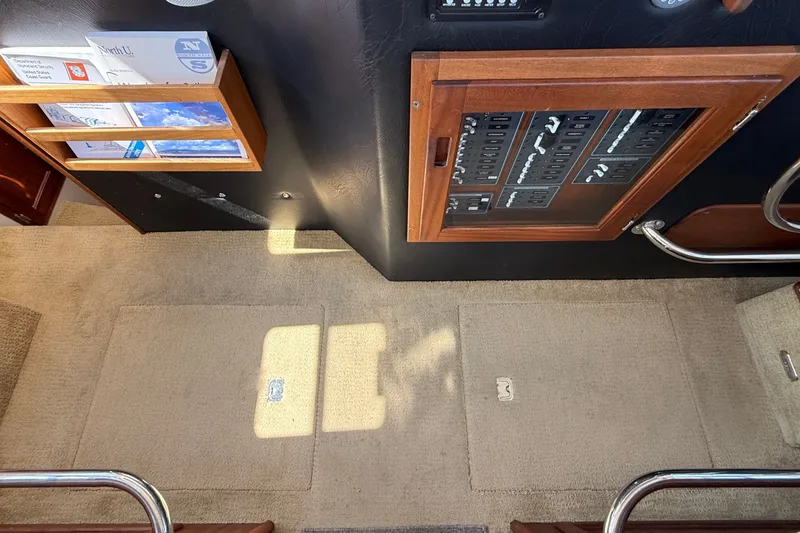 Slide: The Image of Interior view of a 2012 American Tug 365, featuring control panel and carpeted flooring. - 141