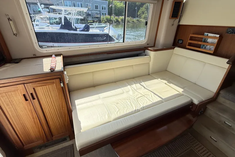 Slide: The Image of Interior of 2012 American Tug 365 with cream sofa and large window view. - 64