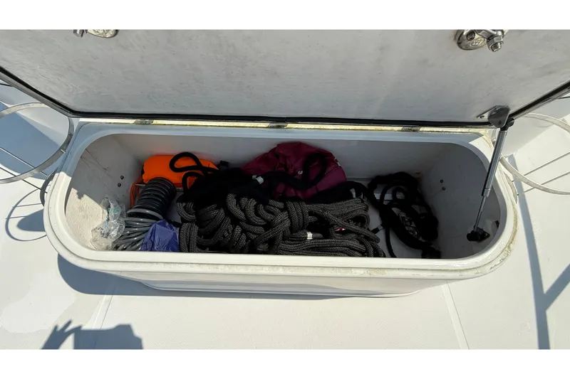 Slide: The Image of Storage compartment on a 2012 American Tug 365, containing ropes and boating gear. - 5